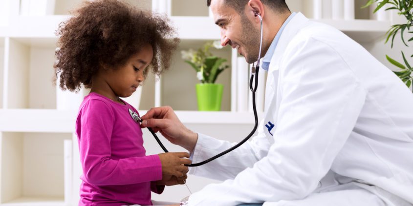 6 Strategies For Pediatricians To Beat Out Retail And Urgent Care Clinics Male pediatrician checking a young girl's heartbeat with a stethoscope