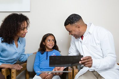 Why EHR Optimization Will be a Dominant Trend over the Next Three Years Dentist showing patient x ray