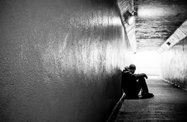 4 Key Financial Performance Indicators for Pediatric Practices Teenager sits along, slumped on the ground in a pedestrian tunnel