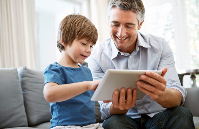 Media Use By Children: Monitor and Model A father and his young son working together with a tablet